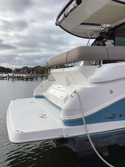  Yacht Photos Pics 2018 Regal 42 Fly yacht docked by the water on a cloudy day.