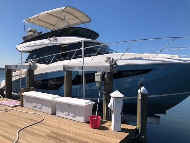 Yacht Photos Pics 2018 Regal 42 Fly yacht docked at a marina under clear blue skies.