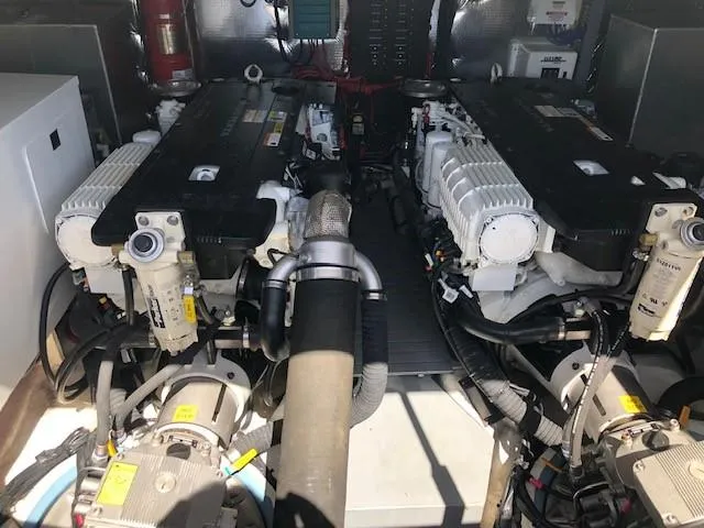 Yacht Photos Pics Engine room of a 2018 Regal 42 Fly yacht, showcasing dual engines and mechanical components.