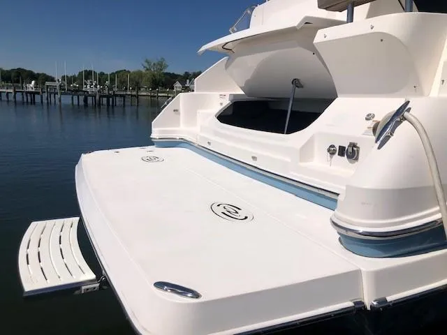  Yacht Photos Pics 2018 Regal 42 Fly yacht docked, showcasing spacious swim platform and sleek design.