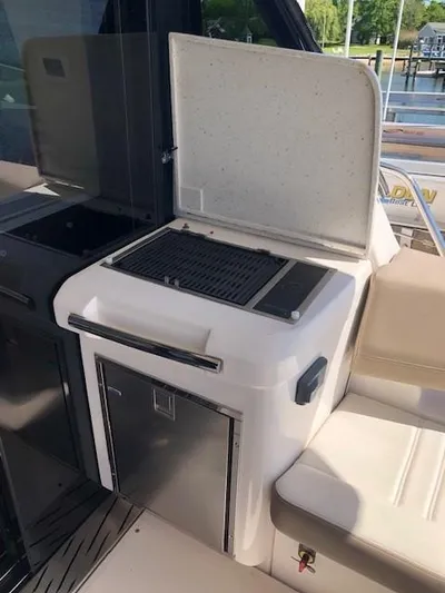 Yacht Photos Pics Outdoor grill on 2018 Regal 42 Fly yacht, featuring stainless steel finish and storage compartment.