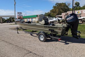 2025 Tracker Grizzly 1754 SC boat with Mercury engine on trailer, parked outdoors.