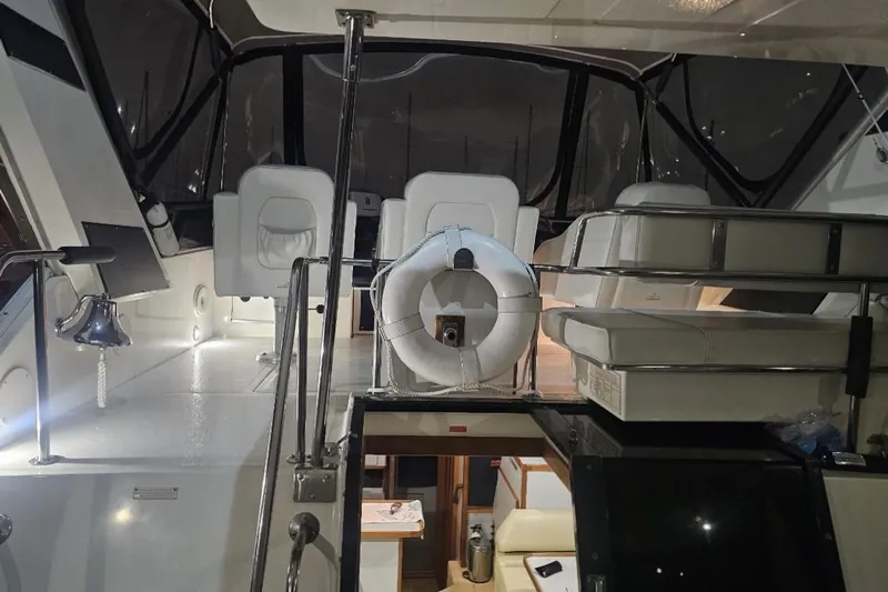 Tenacious Yacht Photos Pics 1990 Sea Ray 380 Aft Cabin interior with seating and life preserver.