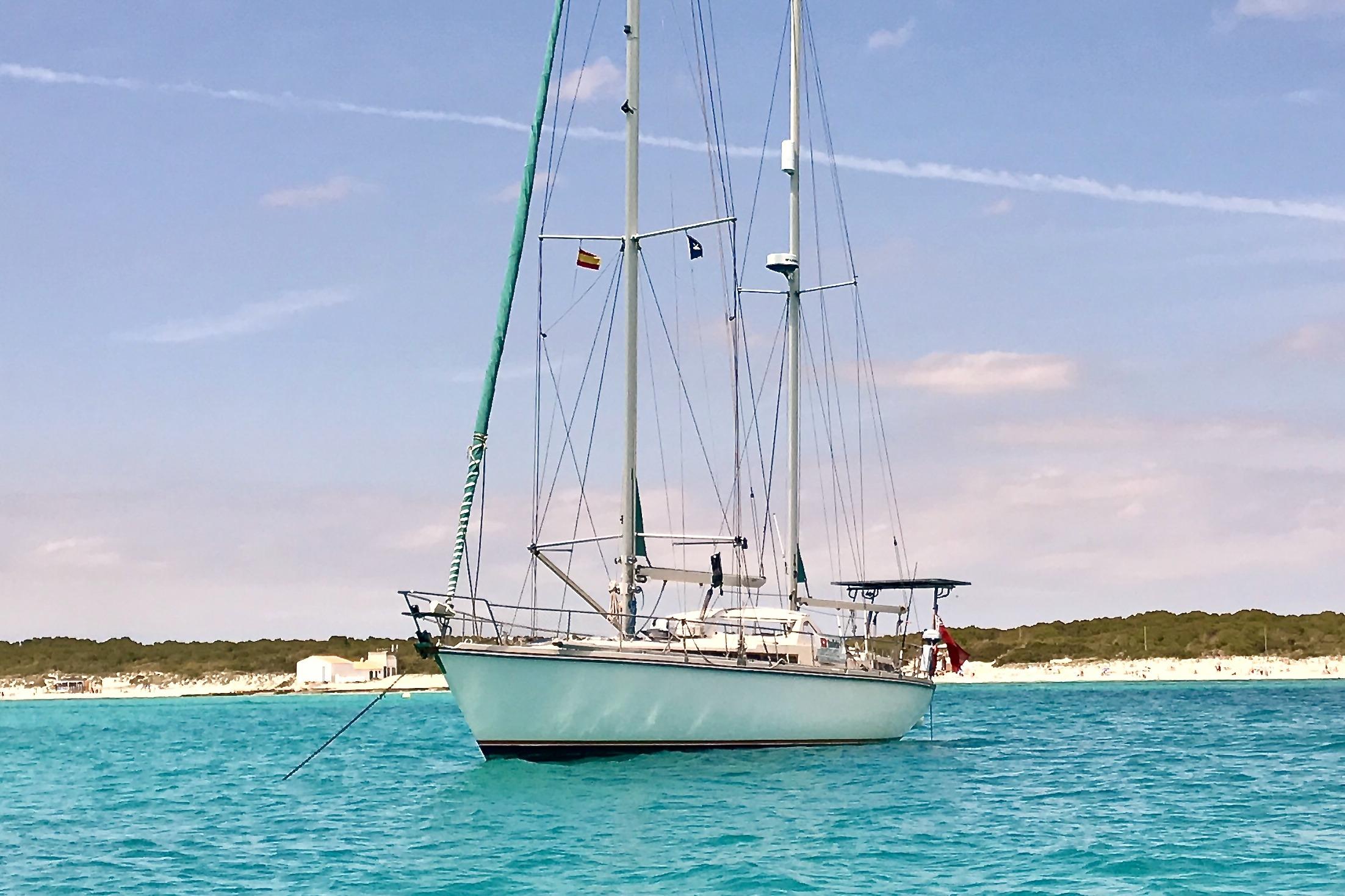 Sailing yacht Amel Super Maramu 1997 anchored in turquoise waters.