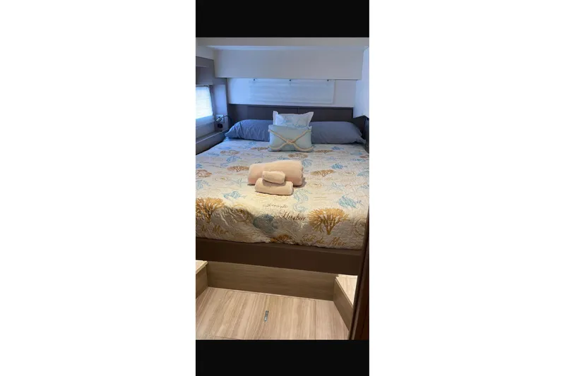 Isthmus Breeze Yacht Photos Pics Cozy bedroom in 2023 Bali 4.2 yacht with nautical-themed bedding and soft lighting.