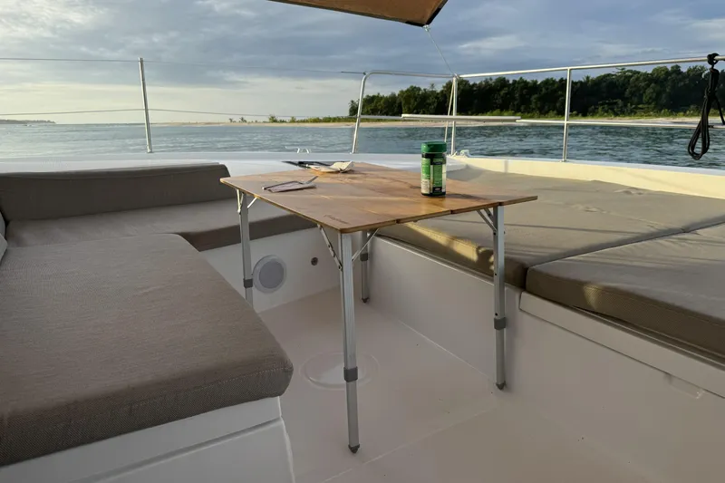 Isthmus Breeze Yacht Photos Pics Cozy seating area on 2023 Bali 4.2 yacht with table, ocean view.