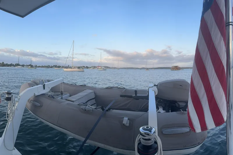 Isthmus Breeze Yacht Photos Pics A 2023 Bali 4.2 yacht with an American flag, overlooking a serene harbor.