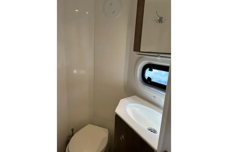 Isthmus Breeze Yacht Photos Pics Compact bathroom in 2023 Bali 4.2 model with sink, toilet, and window.