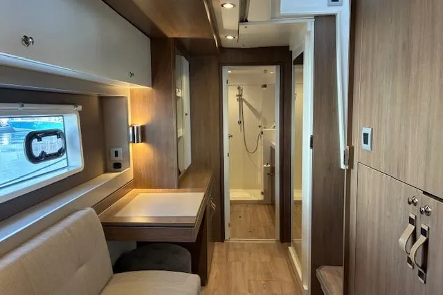 Isthmus Breeze Yacht Photos Pics Modern Bali 4.2 RV interior, featuring a cozy seating area and compact bathroom, 2023 model.