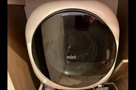 Isthmus Breeze Yacht Photos Pics Compact Bali 4.2 mini washing machine, 2023 model, in a wooden cabinet.