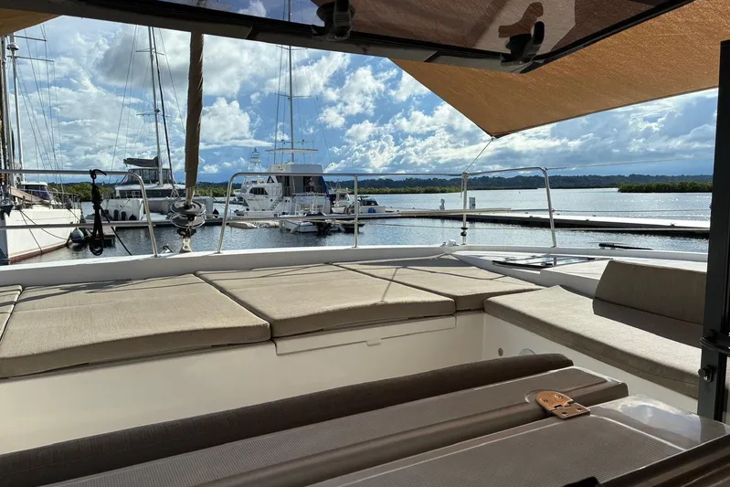 Isthmus Breeze Yacht Photos Pics 2023 Bali 4.2 yacht interior with marina view, featuring comfortable seating and sunshade.