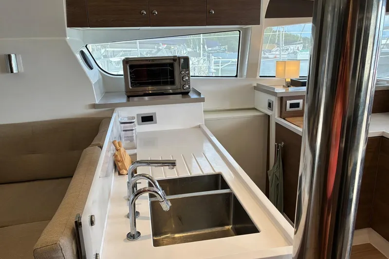 Isthmus Breeze Yacht Photos Pics Modern kitchen interior on 2023 Bali 4.2 yacht with sink, oven, and window view.