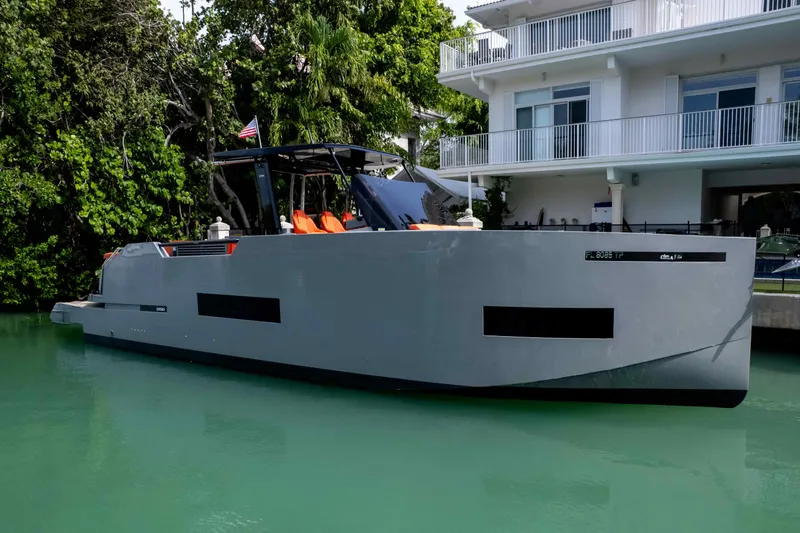  Yacht Photos Pics 2023 De Antonio Yachts D50 moored by a modern waterfront home.