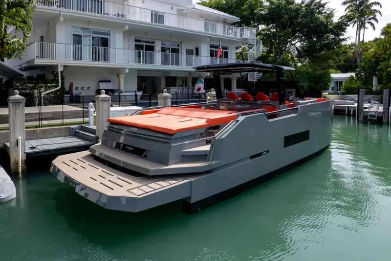 Yacht Photos Pics 2023 De Antonio Yachts D50 docked, featuring sleek design and vibrant orange seating.