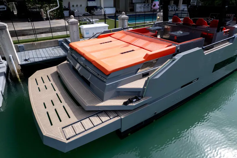  Yacht Photos Pics 2023 De Antonio Yachts D50 docked, featuring sleek design and vibrant orange seating.