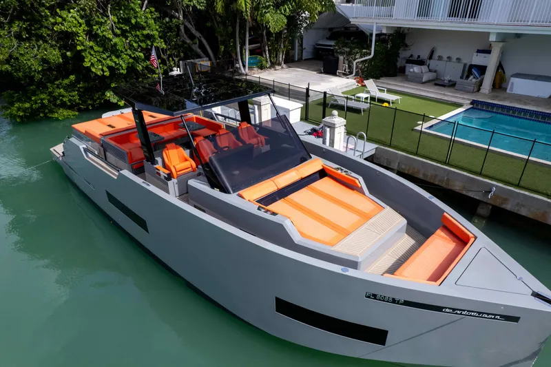  Yacht Photos Pics 2023 De Antonio Yachts D50 with sleek design, docked near a poolside area.