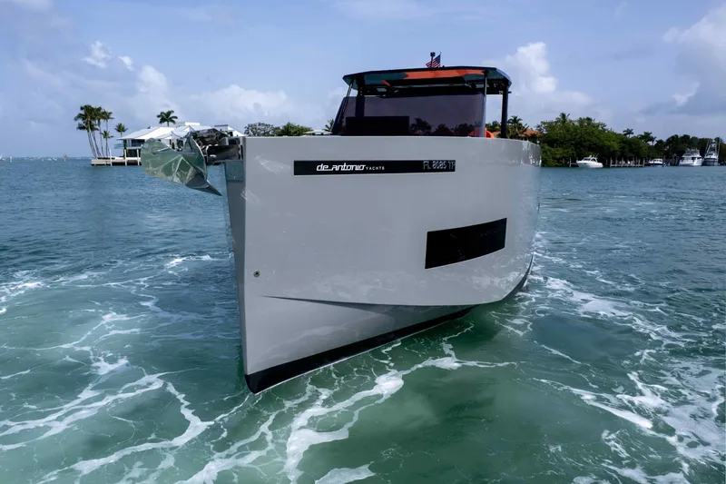  Yacht Photos Pics 2023 De Antonio Yachts D50 cruising on turquoise waters under a clear sky.