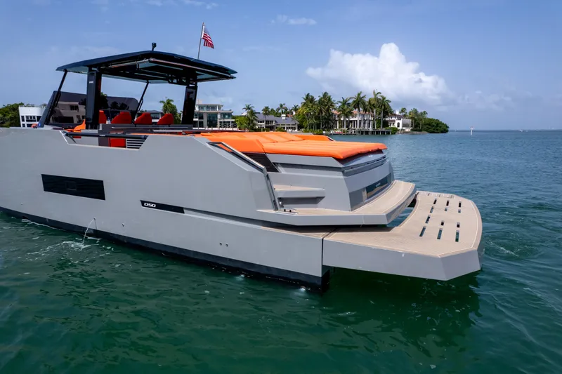  Yacht Photos Pics 2023 De Antonio Yachts D50 luxury yacht on water, featuring sleek design and vibrant orange seating.