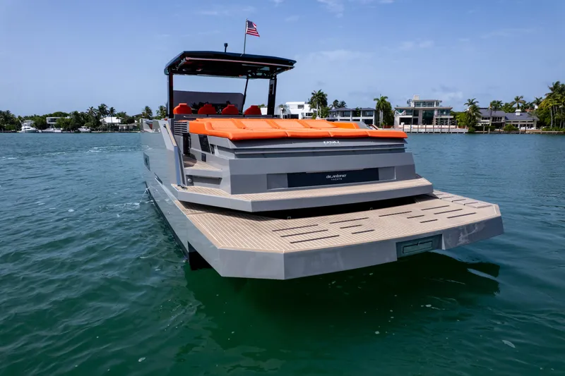  Yacht Photos Pics 2023 De Antonio Yachts D50 luxury yacht on water, featuring sleek design and vibrant seating.