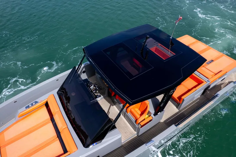  Yacht Photos Pics 2023 De Antonio Yachts D50 with sleek design, vibrant orange seating, cruising on open water.