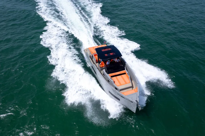  Yacht Photos Pics 2023 De Antonio Yachts D50 cruising on open water, showcasing sleek design and performance.