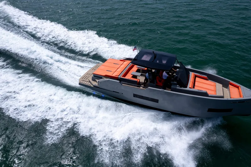  Yacht Photos Pics 2023 De Antonio Yachts D50 cruising on open water, showcasing sleek design and vibrant seating.