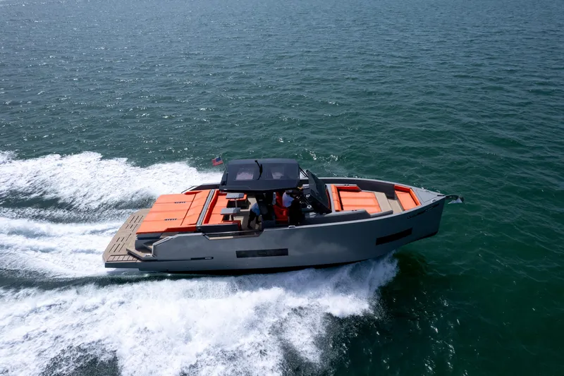  Yacht Photos Pics 2023 De Antonio Yachts D50 cruising on open water, showcasing sleek design and vibrant seating.