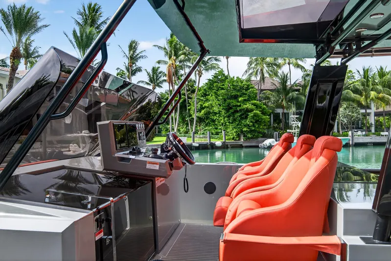  Yacht Photos Pics 2023 De Antonio Yachts D50 cockpit with vibrant orange seats and modern controls.