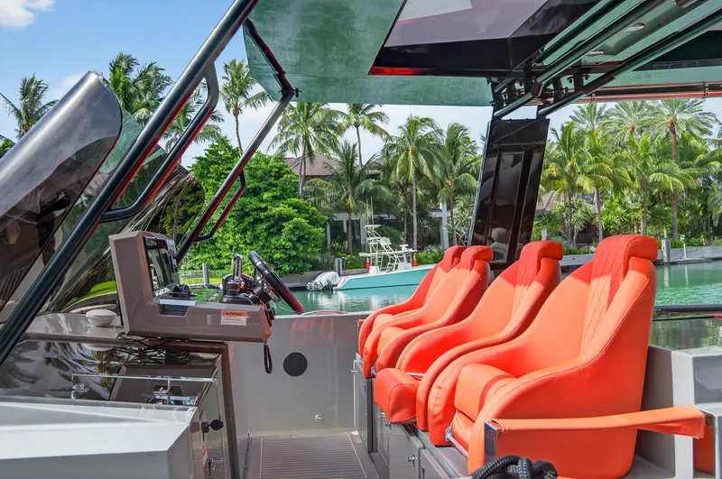  Yacht Photos Pics 2023 De Antonio Yachts D50 interior with vibrant orange seats and modern controls.