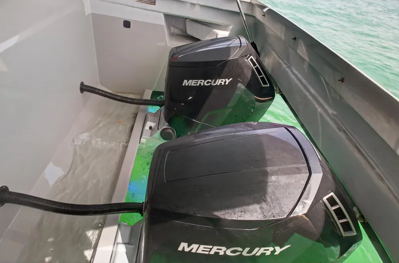  Yacht Photos Pics Twin Mercury outboard engines on a 2023 De Antonio Yachts D50, in clear water.