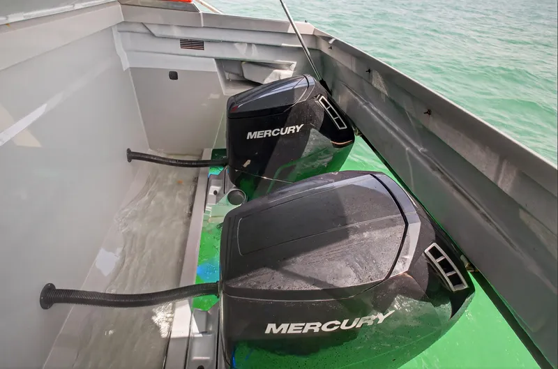  Yacht Photos Pics Twin Mercury outboard engines on 2023 De Antonio Yachts D50, cruising in clear waters.