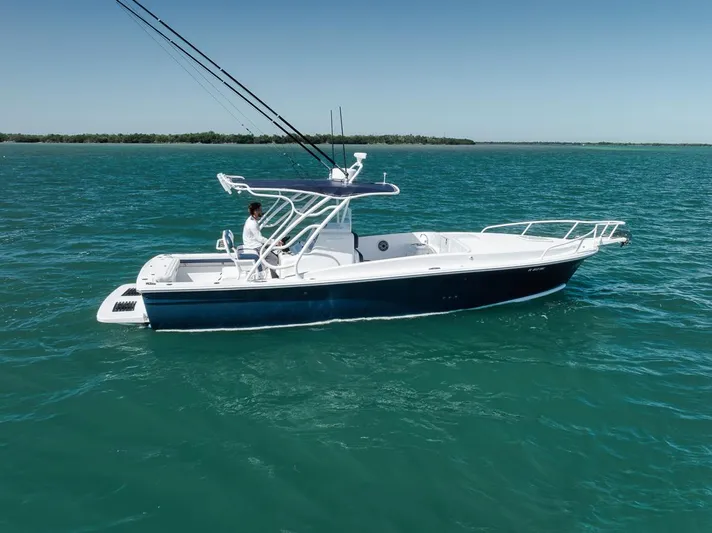  Yacht Photos Pics 2003 Strike 31 Open boat on calm blue water, side view.