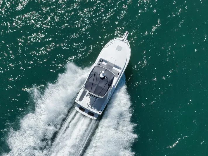  Yacht Photos Pics Aerial view of 2003 Strike 31 Open boat cruising on turquoise water.