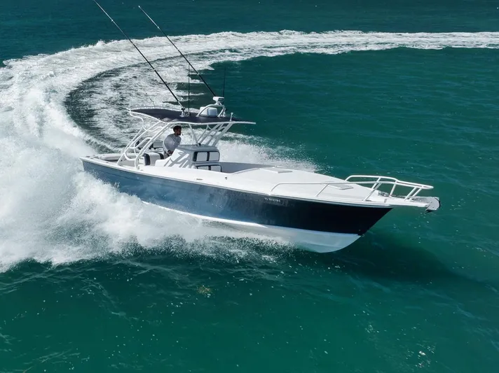  Yacht Photos Pics 2003 Strike 31 Open boat making a sharp turn on turquoise water.