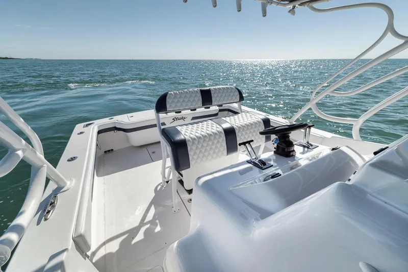  Yacht Photos Pics 2003 Strike 31 Open boat on calm ocean waters, featuring sleek seating and helm.