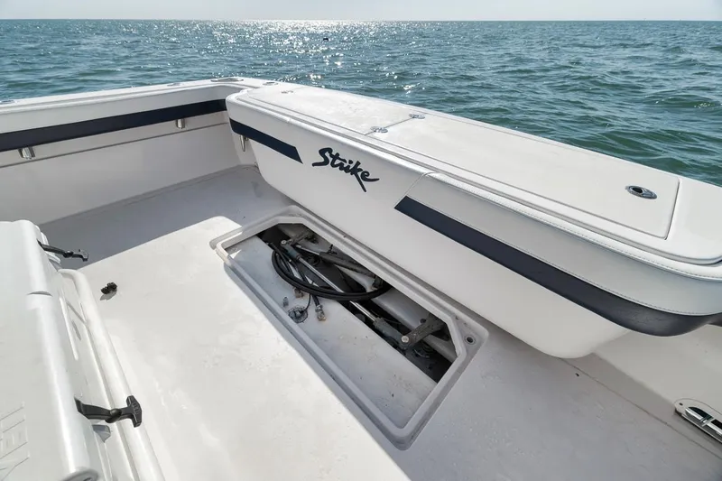  Yacht Photos Pics 2003 Strike 31 Open boat deck with storage compartment, ocean view in background.