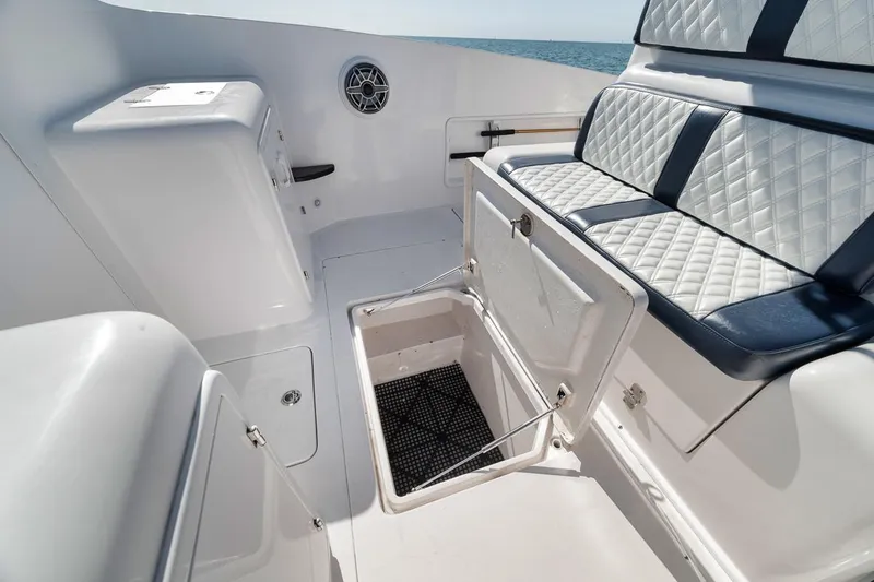  Yacht Photos Pics 2003 Strike 31 Open boat interior with storage compartment and cushioned seating.