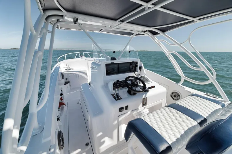  Yacht Photos Pics 2003 Strike 31 Open boat interior with steering console on open water.