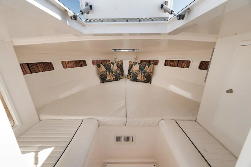  Yacht Photos Pics Interior cabin of 2003 Strike 31 Open boat with cushions and portholes.