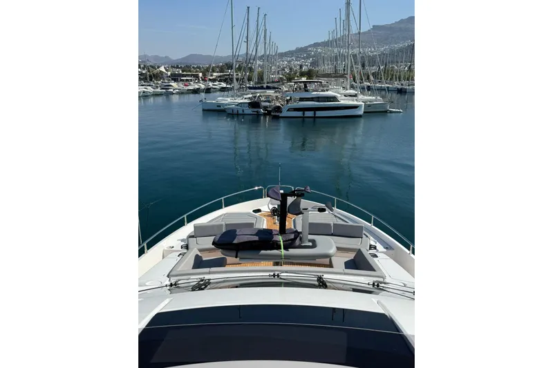 Svetlana Yacht Photos Pics Luxurious 2025 Sunseeker 76 Yacht docked in a scenic marina.