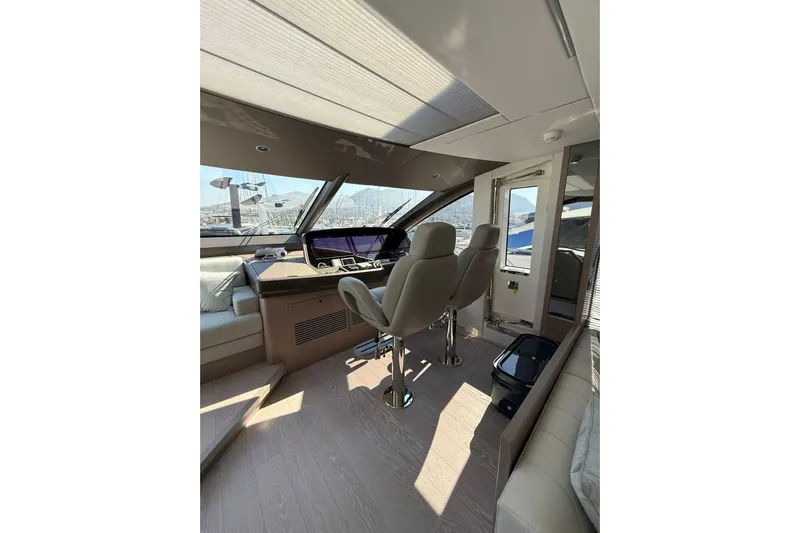Svetlana Yacht Photos Pics Luxurious interior of 2025 Sunseeker 76 Yacht with modern helm and seating.