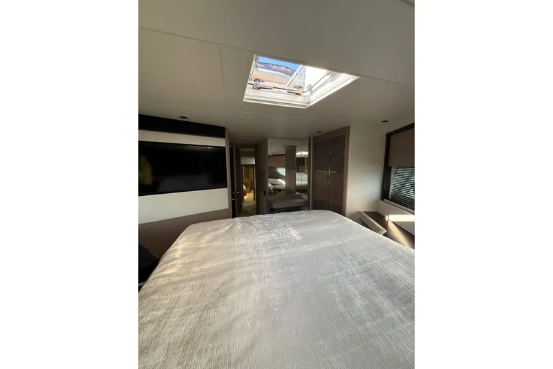Svetlana Yacht Photos Pics Luxurious interior of 2025 Sunseeker 76 Yacht with skylight and modern furnishings.