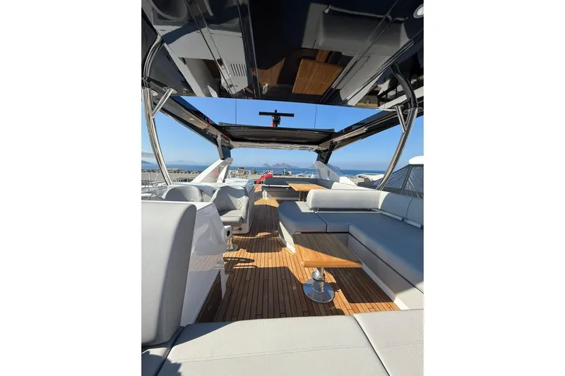 Svetlana Yacht Photos Pics Luxurious 2025 Sunseeker 76 Yacht interior with sleek seating and wooden flooring.