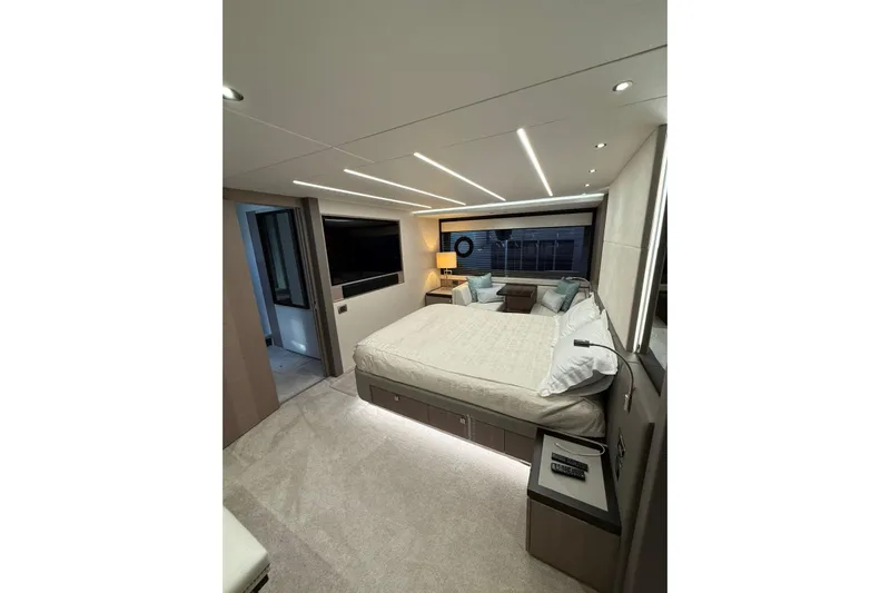 Svetlana Yacht Photos Pics Luxurious bedroom interior of 2025 Sunseeker 76 Yacht with modern design and ambient lighting.