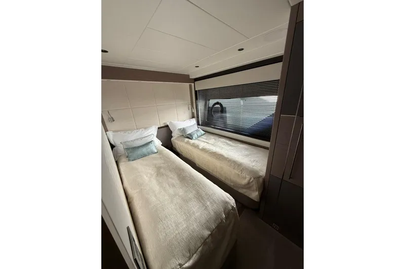 Svetlana Yacht Photos Pics Luxurious twin bedroom in 2025 Sunseeker 76 Yacht, featuring modern design and elegant decor.