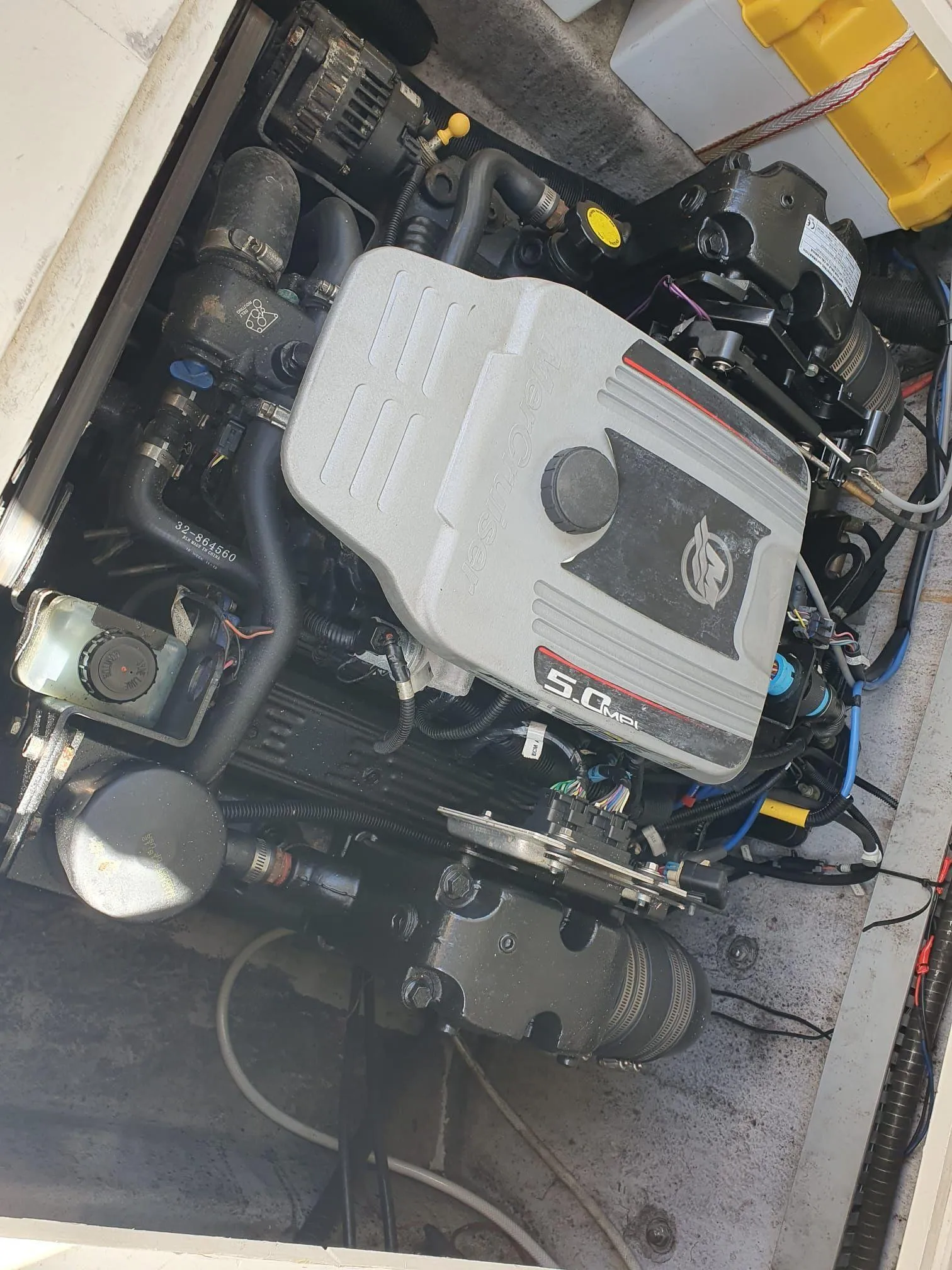 Boat engine compartment with a 5.0 MPI engine, featuring various components and wiring.