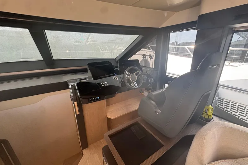  Yacht Photos Pics 2023 Absolute 52 FLY yacht helm with modern controls and comfortable seating.