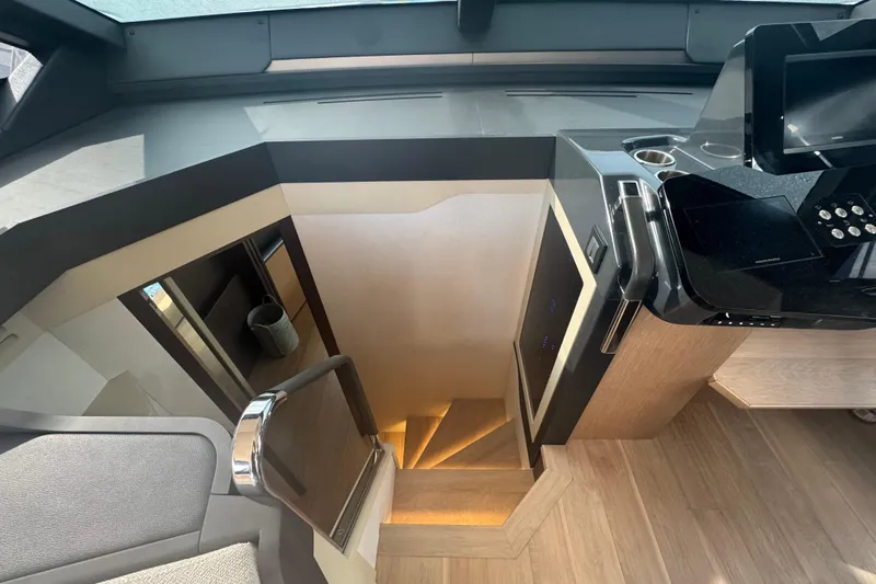  Yacht Photos Pics Interior view of 2023 Absolute 52 FLY yacht, featuring modern staircase and sleek design.