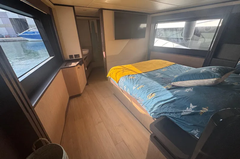  Yacht Photos Pics Luxurious bedroom interior of 2023 Absolute 52 FLY yacht with large windows and modern decor.