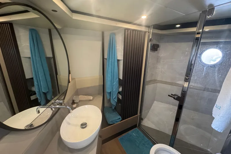  Yacht Photos Pics Luxurious bathroom in 2023 Absolute 52 FLY yacht with modern fixtures and elegant design.